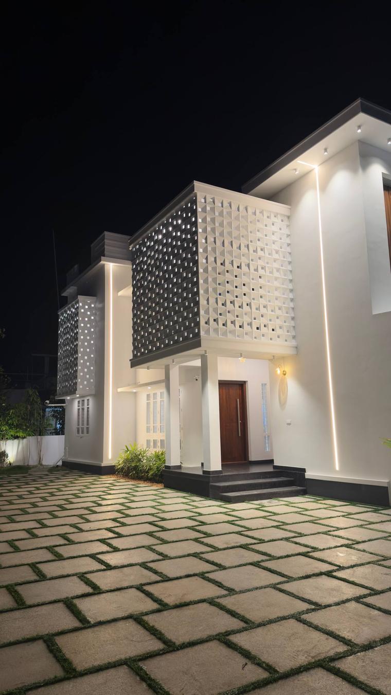 Sanju Residence entrance elevation lit at night